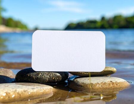 Blank card on rocks in the water photo
