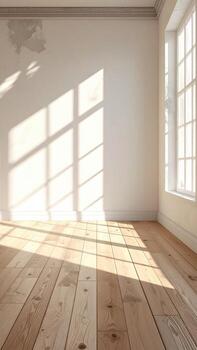 Sunlight streams into a light, empty room with a pale wood floor and white walls photo