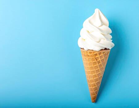 Single scoop of white ice cream in a waffle cone photo