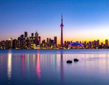 Panoramic city skyline at twilight reflecting on still water photo