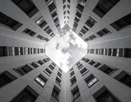 Looking up at a courtyard between apartment buildings photo