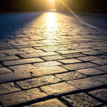 Sunlit cobblestone road photo