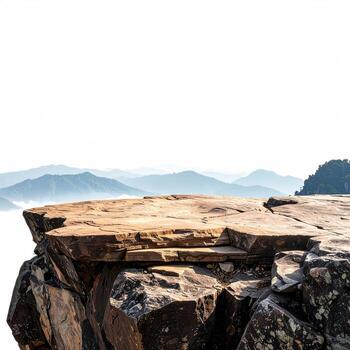 Rocky clifftop platform overlooking misty mountains photo