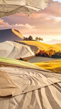 A view through crumpled paper of a sun-drenched landscape photo
