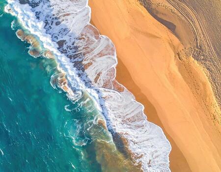 Aerial view of a beach and ocean meeting photo