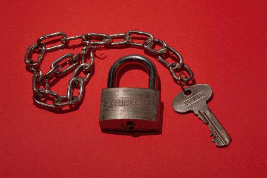 A padlock and keys on a red background photo
