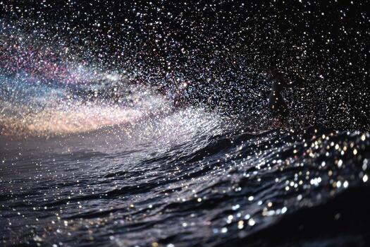 A person is standing on a surfboard in the ocean photo