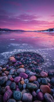 A colorful sunset over a frozen lake with rocks photo
