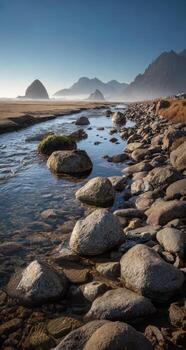 Rocks and water in the ocean with mountains in the background photo