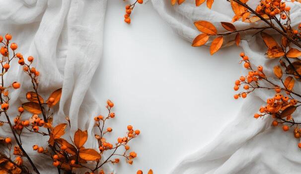 Autumn background with white fabric and orange leaves photo