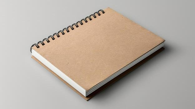 A notebook with a spiral bound cover on a white surface photo