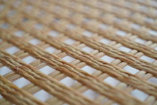 Close-up of a woven bamboo or rattan texture with a diagonal grid pattern image photo