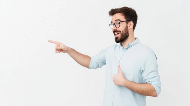 Man with glasses and beard pointing to the left in a light blue shirt against a white background photo
