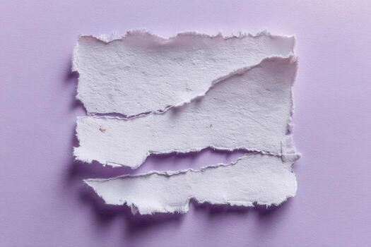 Torn paper pieces on purple background for creative design, textures, and artistic concepts photo