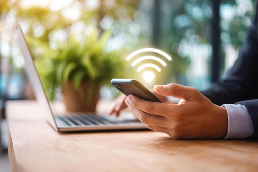 Person using smartphone with wireless signal icon in a modern workspace setting photo