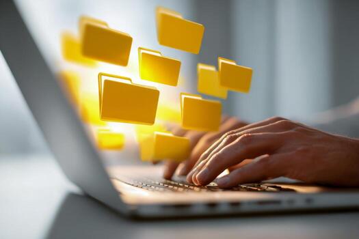Person typing on laptop with glowing digital folder icons floating above keyboard representing file management and data organization in modern technology environment photo