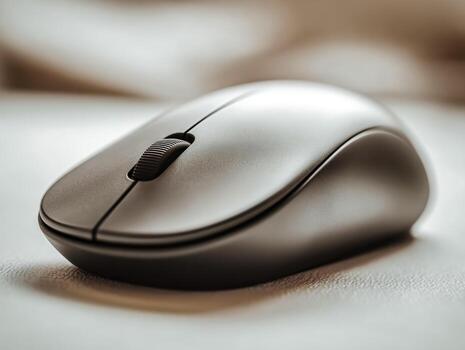 Modern wireless computer mouse on a smooth surface photo