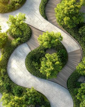 Overhead view of a winding concrete pathway surrounded by lush green trees and shrubs in a garden setting photo