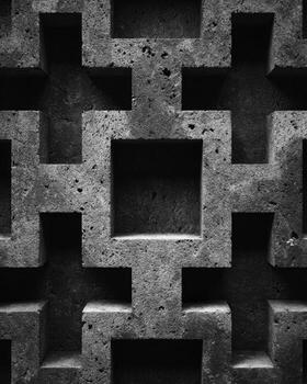 Close-up of a concrete wall with cross-shaped cutouts photo