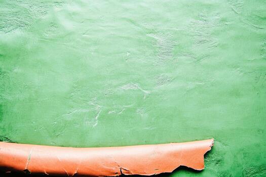 Curled brown paper against a textured green background in soft light photo