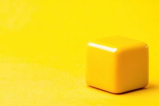 Bright yellow cube on a solid yellow background showcasing a simple design photo