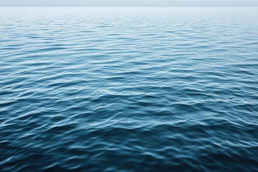 Rippling waves on a serene ocean under a clear sky in daylight photo