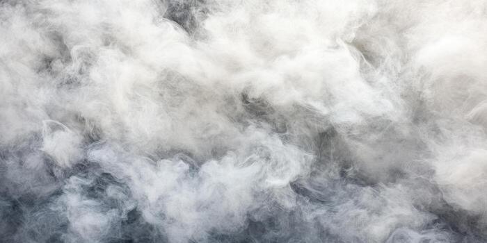 Thick white fog rolls across a dark surface in a mystical setting photo