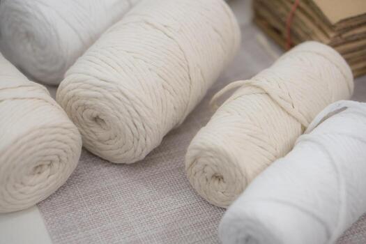 An up-close view of cotton spools used for macrame and craft-making, focusing on the soft fibers, spool details, and how these versatile cords serve as the foundation for numerous creative DIY photo