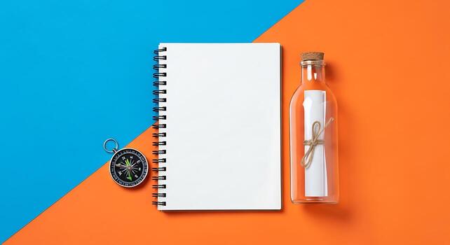 Blank Spiral Notebook Compass Message in a Bottle on Split Blue and Orange Background Space for Text Top View Flat Lay photo