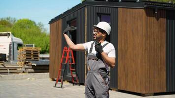 Construction worker explaining and pointing on site video