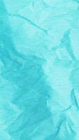 Crumpled paper stop motion animation, Textured tosca paper vertical background. The concept of sketch pad, design, retro style, wrinkle, frayed, blank video