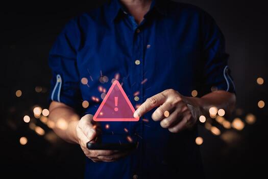 A person interacts with a smartphone, trigger a glow red warning symbol with an exclamation mark. The digital caution alert appears surrounded by bokeh lights, symbol a notification or error message. photo