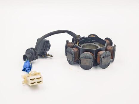 This image shows a motorcycle engine stator coil assembly part, which is an essential component used for generating electricity to power the electrical system. photo