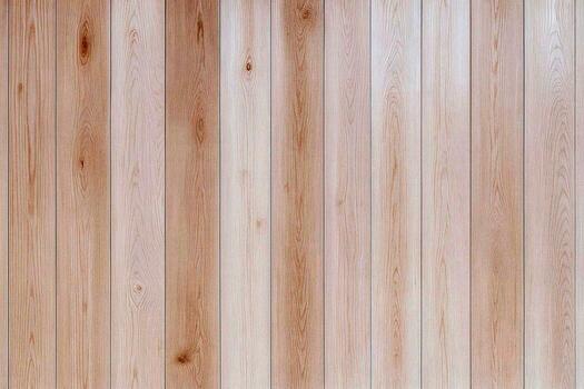 Light toned vertical wooden planks with fine grain variation and soft natural shading arranged in neat lines to create a calm airy panel that brings warmth simplicity and a gentle handcrafted photo