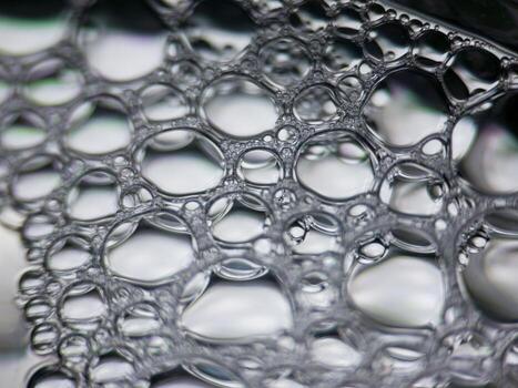 Closeup macro view of soap bubbles forming abstract pattern photo