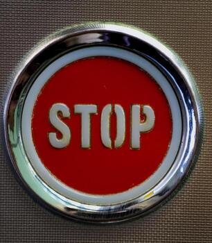 Close up of red stop button with metallic chrome frame photo