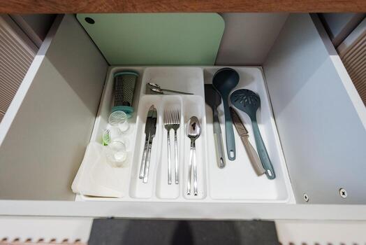 An Organized Kitchen Drawer featuring an Array of Utensils and Cutlery to Enhance Aesthetics and Efficiency in Your Cooking Space, Perfect for achieving a Clean, Neat, and Functional Layout photo