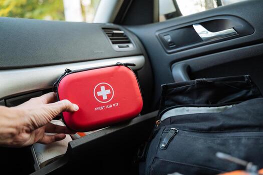 It is crucial to have an essential car emergency kit in your vehicle, which should ideally include a red first aid case stored conveniently in the vehicle console for easy access during emergencies photo