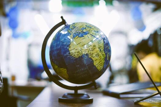 Colorful Globe Display on a Wooden Desk in Blurred Modern Setting photo