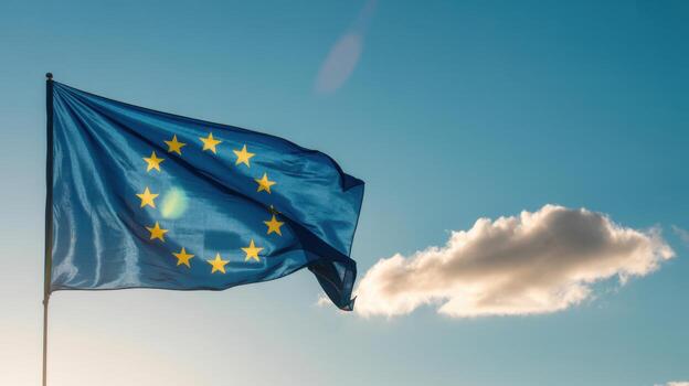 European union flag waving in the wind against a blue sky with a few clouds, symbolizing unity and cooperation among member states photo