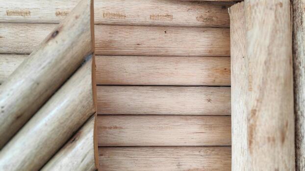 Wooden logs form a rustic wall in a cabin, showcasing natural patterns and textures, creating a warm and inviting atmosphere. photo