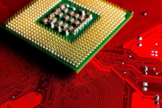 Macro photo of a computer microprocessor on a red background. Printed circuit board, top view, with chip and capacitors, close-up photo