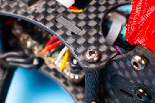 A close-up of a self-assembled drone assembled on a carbon fiber frame with exposed electronics. DIY assembly of unmanned aerial vehicles for a wide range of applications. photo