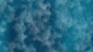 Abstract background of swirling blue smoke and clouds, a dynamic and atmospheric digital texture video