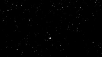 Abstract white particles falling on a dark black background, creating a subtle snow-like or dust overlay texture, perfect for motion graphics, digital design elements, and cinematic backdrops video