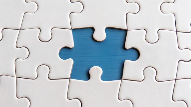 Puzzle pieces fitting together, creating sense of completion and unity, with one piece missing, symbolizing need for connection and resolution photo