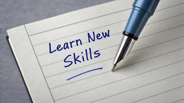 Pen writing on notepad close up with words learn new skills, conveying sense of motivation and personal growth. image captures essence of education and self improvement photo