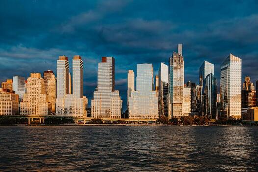 Skyscrapers in Manhattan reflecting evening light. Manhattan skyline showcases modern architecture glowing in evening light with a serene water view at dusk. photo