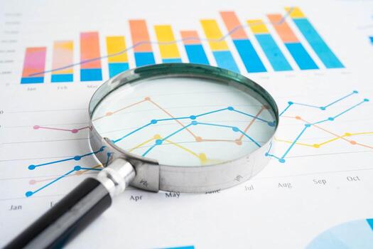 Magnifying glass on charts graphs paper. Financial development Account, Statistic, Investment Analytic data photo
