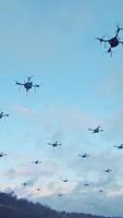 Swarm of Drones Flying at Dusk. A group of drones hovering in the sky at dusk, showcasing advanced aerial technology. video